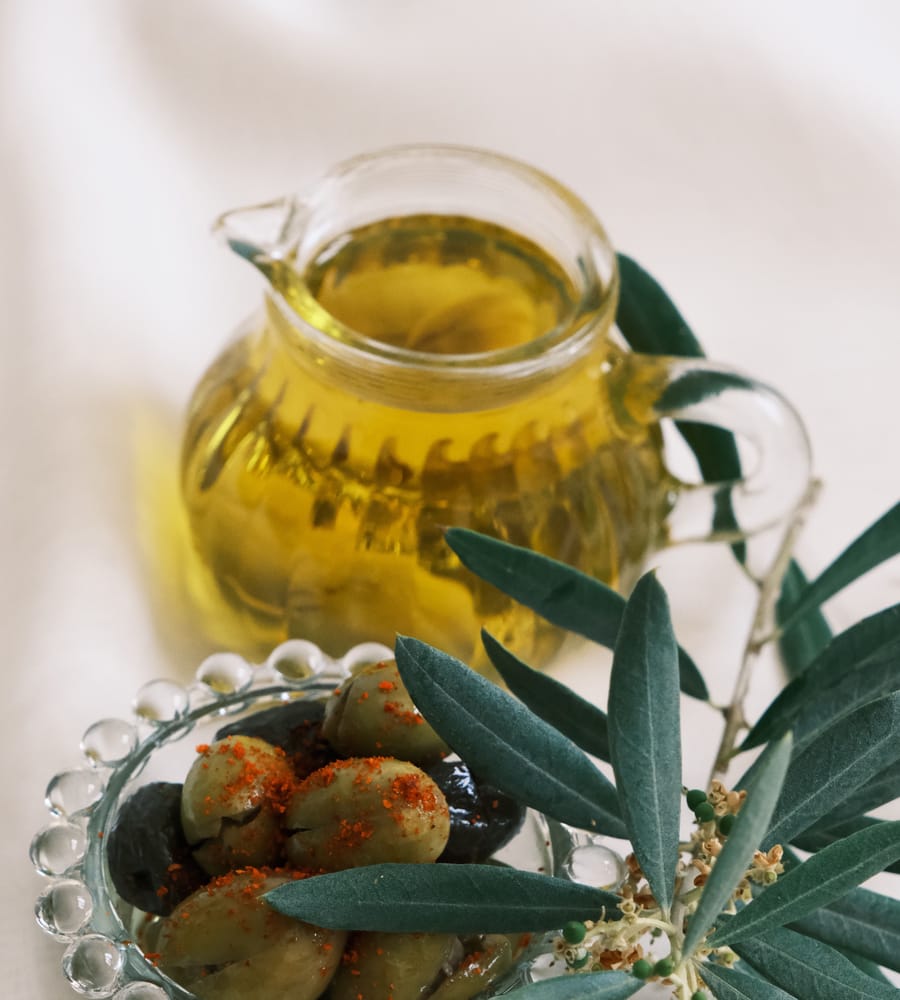 Bottle of Greek extra virgin olive oil being poured.