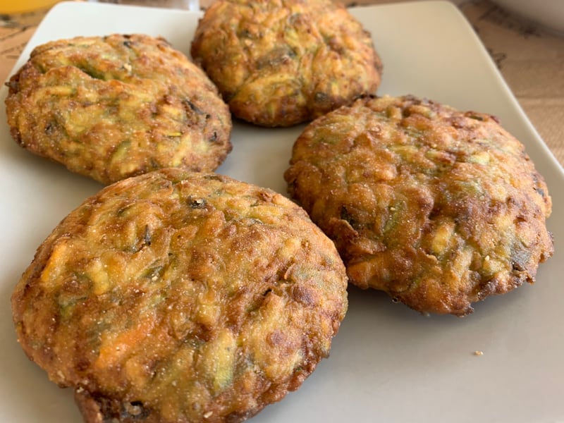 A close-up plate of golden fried kolokithokeftedes at a Crete taverna, crisp edges visible.
