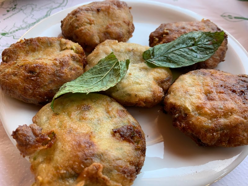 A second plate of zucchini fritters from a different Crete taverna, herbed and lightly golden.