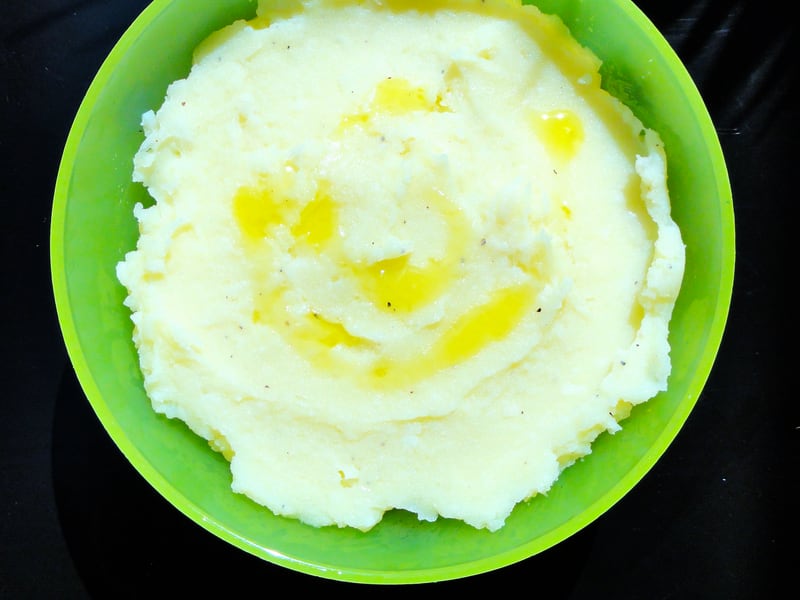 A bowl of skordalia, Greek garlic and potato dip, drizzled with olive oil.